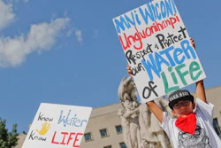 Tusweca Mendoza, 10, of Arlington, Va., originally from Pine Ridge, S.D., holds up a sign outside U.S. District Court in Washington, Tuesday, Sept. 6, 2016, as members of the Standing Rock Sioux Tribe have asked a federal judge to temporarily stop work on parts of the Dakota Access Pipeline to prevent the destruction of sacred and culturally significant sites near Lake Oahe.