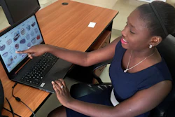 Design engineering graduate Youma Fall shows pictures of baskets, the inspiration for another app she might later pursue to help women sell local products from her PayDunya office in Dakar, Senegal.