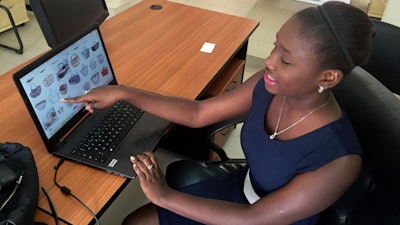 Design engineering graduate Youma Fall shows pictures of baskets, the inspiration for another app she might later pursue to help women sell local products from her PayDunya office in Dakar, Senegal.