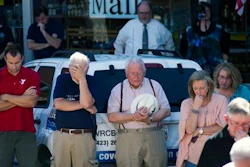 People pause for prayer during a vigil for the victims of the Thomas & Betts plant shooting, Friday, Sept. 23, 2016, in Athens, Tenn. Ricky Swafford who fatally shot two supervisors and then killed himself at an electrical components plant in eastern Tennessee had a state-issued permit to carry handguns in public, law enforcement officials said Friday.