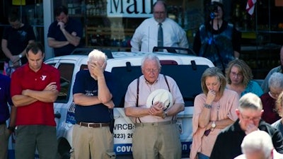 People pause for prayer during a vigil for the victims of the Thomas & Betts plant shooting, Friday, Sept. 23, 2016, in Athens, Tenn. Ricky Swafford who fatally shot two supervisors and then killed himself at an electrical components plant in eastern Tennessee had a state-issued permit to carry handguns in public, law enforcement officials said Friday.