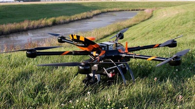 This Aug. 29, 2016, file photo provided by Sharper Shape and SkySkopes shows a Sharper A6 drone before a test to fly over power lines in eastern North Dakota near Blanchard. The drone is specially designed for utility asset inspections. The drone is being tested as part of a project by Xcel Energy to see of unmanned aircraft can help crews restore power to areas hit by natural disasters. Officials with the company hope to be flying beyond visual line of sight by the end of the year.