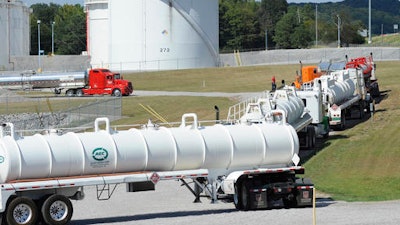 Tanker trucks line up at a Colonial Pipeline Co. facility in Pelham, Ala., near the scene of a 250,000-gallon gasoline spill on Friday, Sept. 16, 2016. The company says spilled gasoline is being taken to the storage facility for storage. Some motorists could pay a little more for gasoline in coming days because of delivery delays.