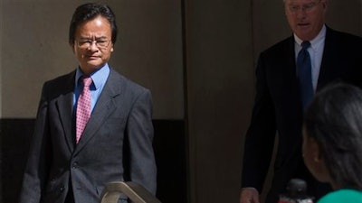 Volkswagen engineer James Robert Liang, left, leaves court, Friday, Sept. 9, 2016, in Detroit, after pleading guilty to one count of conspiracy in the company’s emissions cheating scandal, Liang has agreed to cooperate in the widening criminal investigation.