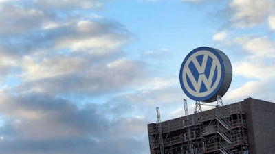 In this Sept. 26, 2015 file photo a giant logo of the German car manufacturer Volkswagen is pictured on top of a company's factory building in Wolfsburg, Germany. A German court says Wednesday, Sept. 21, 2016 it has added staff and storage space to handle a flood of 1,400 investor lawsuits against Volkswagen seeking damages worth 8.2 billion euros (US dollar 9.2 billion).