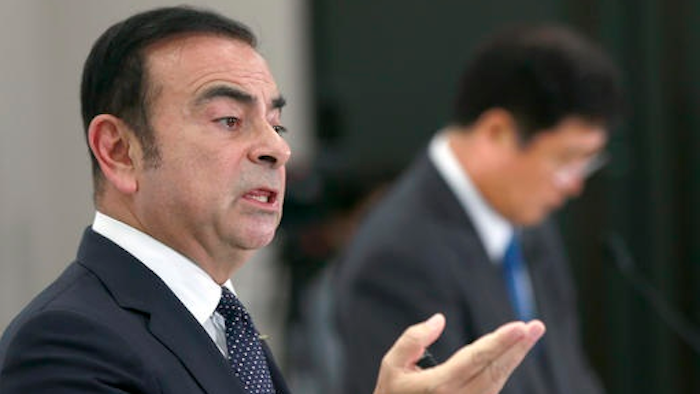 Nissan Motor Co. CEO Carlos Ghosn speak as Mitsubishi Motors Corp. CEO Osamu Masuko, right, listens during a joint press conference in Tokyo, Thursday, Oct. 20, 2016.