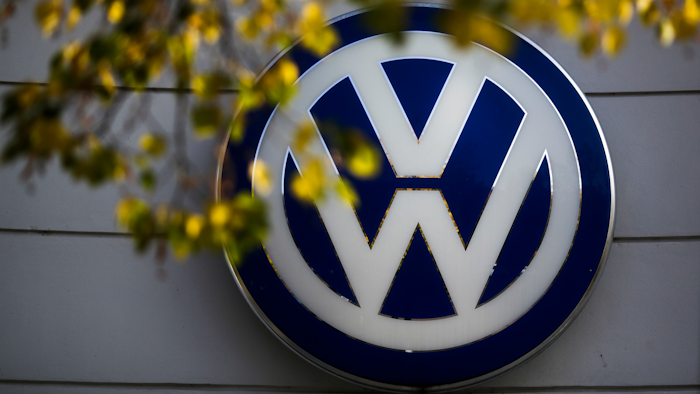 In this file photo, the VW sign of Germany's Volkswagen car company is displayed at a retailer in Berlin. U.S. District Judge Charles Breyer has scheduled a hearing to determine whether the deal is fair to consumers and should receive final approval.