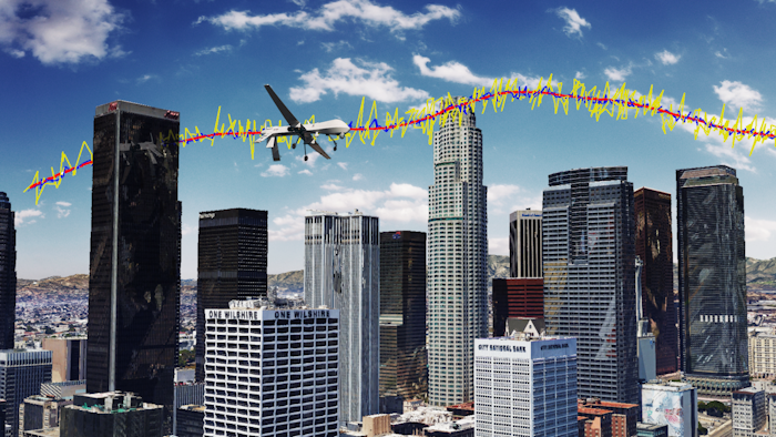 Simulation results for an unmanned drone flying over downtown Los Angeles showing the true trajectory (red line), with GPS navigation only (yellow line), and GPS aided with cellular signals (blue line).