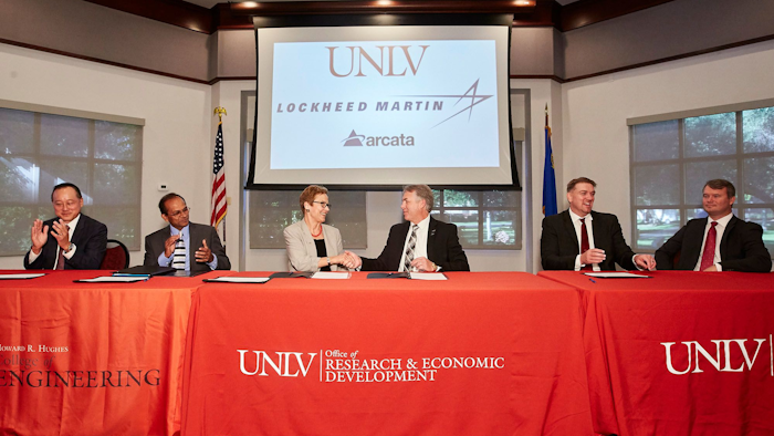 Diane Chase, UNLV Executive Vice President and Provost, shakes hands after signing agreement with Scott Jones, director of civil space supply chain management at Lockheed Martin.
