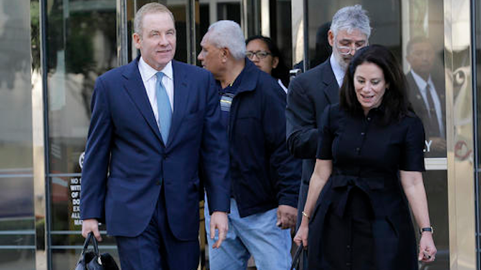 Robert Giuffra, an attorney for Volkswagen, left, leaves the Phillip Burton Federal Building in San Francisco, Tuesday, Oct. 18, 2016. Several angry Volkswagen owners told a federal judge on Tuesday that a $10 billion settlement does not adequately compensate them for the automaker's emissions cheating scandal.
