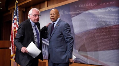 In this Sept. 10, 2015 file photo, Sen. Bernie Sanders, I-Vt., left, and Rep. Elijah Cummings, D-Md., leave a news conference on Capitol Hill in Washington. Sanders and Cummings on Thursday, Oct. 20, 2016, demanded information from a drug company that has raised prices on a leukemia drug, calling increases of tens of thousands of dollars a sign the company puts profits before patients.