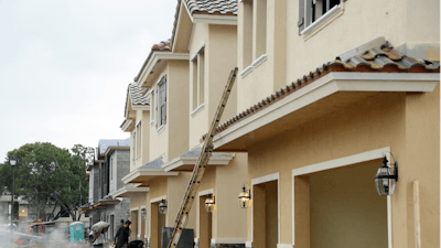 In this file photo, Lennar Corporation townhomes are under construction at Chelsea Place in Tamarac, Fla. The Commerce Department recently reported that U.S. home construction was down in September.