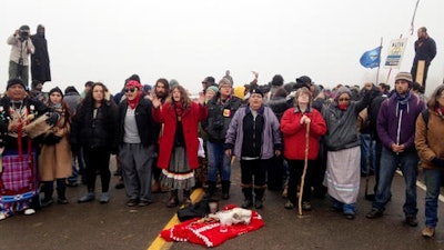 Protesters against the construction of the Dakota Access oil pipeline block a highway in near Cannon Ball, N.D., on Wednesday, Oct. 26, 2016. Law enforcement officials have asked people protesting the Dakota Access oil pipeline to vacate an encampment on private land, and the protesters said no. Protesters are trying to halt construction of the pipeline they fear will harm cultural sites and drinking water for the Standing Rock Sioux.