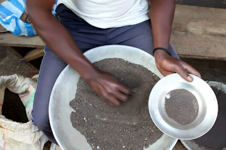 In this file photo a Congolese miner sifts through ground rocks to separate out the cassiterite, the main ore that’s processed into tin, in the town of Nyabibwe, eastern Congo.