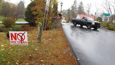 A yard sign opposing an industrial wind project sits at the side of the road in Grafton, Vt. Voters in Grafton and Windham are going to cast ballots Nov. 8 on whether to go forward with a plan for 24 turbines in the two communities. Developer Iberdrola Renewables is offering residents of the two towns direct payments if the project is built.