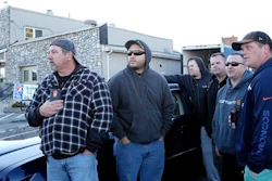 Norfolk Southern employees wait down the road to be let into work, as the company placed a hold on entering the railyard, after the shooting at FreightCar America Tuesday morning, Oct. 25, 2016. Police say a man fatally shot someone and wounded several others inside FreightCar America, a rail car manufacturing company, before apparently killing himself.