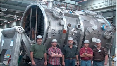Members of the DIII-D Neutral Beam Group in front of a beam housing for two of the eight beamlines.
