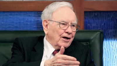 In this Monday, May 4, 2015, file photo, Berkshire Hathaway Chairman and CEO Warren Buffett speaks during an interview with Liz Claman on the Fox Business Network in Omaha, Neb. Buffett has a high-class problem: cash is piling up at Berkshire Hathaway faster than he can invest it.
