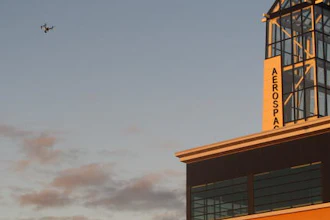 In this Sept. 28, 2016 photo, This drone being flown by University of North Dakota students hovers over an aerospace building in Grand Forks, North Dakota. The flying session was part of the school's first drone business class that is meant to show students what it will take to further their unmanned aircraft careers. One student calls the class a 'game-changer' and another believes it will help him launch a drone business.