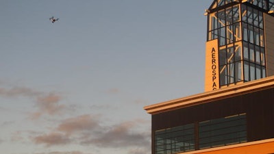 In this Sept. 28, 2016 photo, This drone being flown by University of North Dakota students hovers over an aerospace building in Grand Forks, North Dakota. The flying session was part of the school's first drone business class that is meant to show students what it will take to further their unmanned aircraft careers. One student calls the class a 'game-changer' and another believes it will help him launch a drone business.