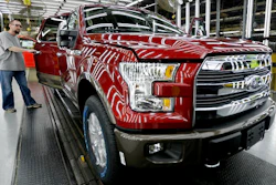 In this March 13, 2015, file photo, a worker inspects a new 2015 aluminum-alloy body Ford F-150 truck at the company's Kansas City Assembly Plant in Claycomo, Mo. U.S. safety regulators are investigating whether a recall of Ford F-150 pickup trucks for brake failures should be expanded to more model years. The probe covers about 282,000 pickups with 3.5-liter six-cylinder engines from 2015 and 2016.