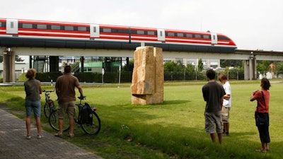 In this Friday, Aug. 1, 2008 file photo, people watch the then new Transrapid train TR09 on the tracks of the magnetic highspeed train test course in Lathen, northern Germany. Germany is auctioning off a maglev train that officials once hoped would speed up transport at home and become a major export success. The train is on show Tuesday and Wednesday, Oct. 11-12, 2016, to would-be buyers at a former test track in northwestern Germany, near the Dutch border.