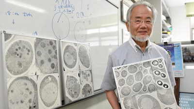 In this July, 2016 photo, Japanese scientist Yoshinori Ohsumi smiles at the Tokyo Institute of Technology campus in Yokohama, south of Tokyo. Ohsumi was awarded this year's Nobel Prize in medicine on Monday, Oct. 3, for discoveries related to the degrading and recycling of cellular components. The Karolinska Institute honored Ohsumi for 'brilliant experiments' in the 1990s on autophagy, the machinery with which cells recycle their content. Disrupted autophagy has been linked to various diseases including Parkinson's, diabetes and cancer, the institute said.