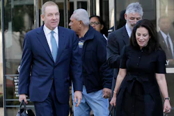 Robert Giuffra, an attorney for Volkswagen, left, leaves the Phillip Burton Federal Building in San Francisco, Tuesday, Oct. 18, 2016. Several angry Volkswagen owners told a federal judge on Tuesday that a $10 billion settlement does not adequately compensate them for the automaker's emissions cheating scandal.