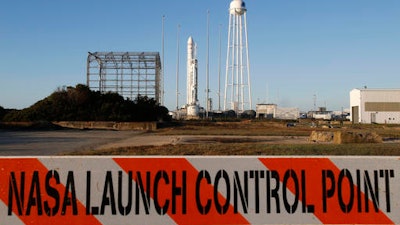 A barricade warns visitors as workers do final preparations for the launch of Orbital ATK Antares rocket at the NASA Wallops Island flight facility in Wallops Island, Va., Sunday, Oct. 16, 2016. A bad cable delayed a rocket launch from Virginia on Sunday by a NASA shipper eager to make a strong comeback.