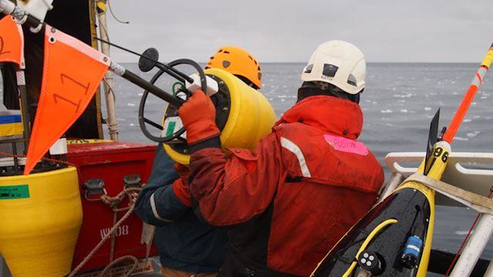 Researchers prepare to drop a buoy into the Arctic Ocean. Scientists sponsored by the Office of Naval Research have traveled to the region to study the changing environment-and provide new tools to help the US Navy operate in a once-inaccessible area.