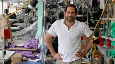 In this April 3, 2012, file photo, Dov Charney, founder of American Apparel, poses for photos at the company's factory in downtown Los Angeles. American Apparel announced Monday, Nov. 14, 2016, that the company is filing for bankruptcy protection for the second time in just over a year, unable to find its footing after a contentious fight for control with founder Charney.