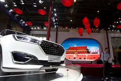 In this April 25, 2016 file photo, visitors to Auto China 2016 stand near Zotye Auto's T300 SUV displayed in Beijing, China. China's auto sales rose 20.3 percent in October from a year earlier, propelled by surging demand for sport utility vehicles, an industry group reported Thursday, Nov. 10, 2016.