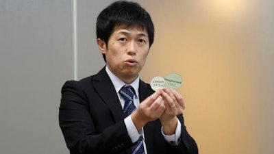 Toyota Motor Corp. engineer Hisao Yamashige speaks to reporters at the Japanese automaker's Tokyo office Thursday, Nov. 24, 2016. Toyota says it has developed a new way of observing the movements of tiny particles in a battery used to power electric vehicles — an advance it says will help boost their cruise range by 10 percent to 15 percent. Yamashige explained to reporters the complex method for tracking the lithium ions, which are tiny particles in lithium-ion batteries, also used in laptops and smartphones.