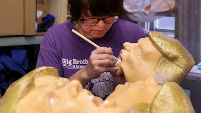 A worker paints a rubber mask depicting President-elect Donald Trump at Ogawa Studio in Saitama, north of Tokyo. Ogawa Studio is working non-stop to catch up with a flood of orders for Trump masks since his election victory one week ago.