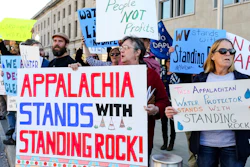 Protesters demonstrate outside of the US Army Corps of Engineers office in Huntington, W.Va., in solidarity with opponents of the Dakota Access oil pipeline.