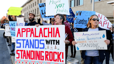 Protesters demonstrate outside of the US Army Corps of Engineers office in Huntington, W.Va., in solidarity with opponents of the Dakota Access oil pipeline.