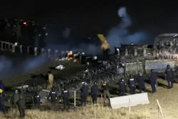 Law enforcement and protesters clash near the site of the Dakota Access pipeline on Sunday, Nov. 20, 2016, in Cannon Ball, N.D. The clash came as protesters sought to push past a bridge on a state highway that had been blockaded since late October, according to the Morton County Sheriff's Office.