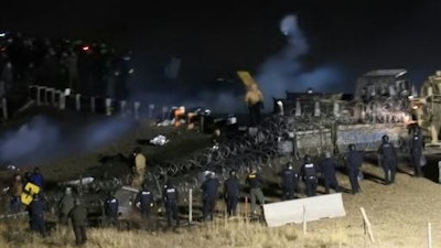 Law enforcement and protesters clash near the site of the Dakota Access pipeline on Sunday, Nov. 20, 2016, in Cannon Ball, N.D. The clash came as protesters sought to push past a bridge on a state highway that had been blockaded since late October, according to the Morton County Sheriff's Office.