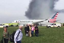 In this photo provided by passenger Jose Castillo, taken Oct. 28, 2016, fellow passengers walk away from a burning American Airlines jet that aborted takeoff and caught fire on the runway at Chicago's O'Hare International Airport. An engine disk that broke apart and forced an American Airlines jet to abort a takeoff in Chicago last week shows signs of fatigue cracking, according to a preliminary report released Friday, Nov. 4, 2016, by accident investigators.