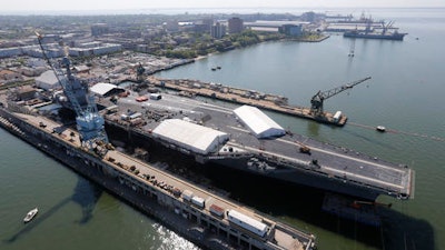 In this April 27, 2016 photo, USS Gerald R. Ford is stationed at Newport News Shipbuilding in Newport News, Va. The $12.9 billion warship, the first of the Navy’s next generation of aircraft carriers, is in the final stages of construction after cost overruns and a delay of more than one year. This carrier and those that will follow are being built to replace the Nimitz-class carriers, which were first commissioned in 1975.