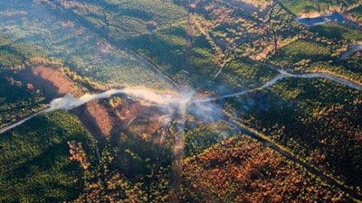 A fog of smoke covers the trees near an explosion of a Colonial Pipeline, Tuesday, Nov. 1, 2016, in Helena, Ala. The pipeline explosion occurred on Monday. The blast, which sent flames and thick black smoke soaring over the forest, happened about a mile west of where the pipeline ruptured in September, Gov. Robert Bentley said in a statement.