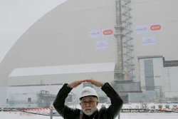 A worker explains a structure of an arch-shaped enclosure in Chernobyl, Ukraine, Tuesday, Nov. 29, 2016. The gargantuan arch-shaped enclosure has begun slowly moving towards the exploded Chernobyl nuclear reactor, in what represents a significant step toward liquidating the remains of the world's worst nuclear accident.