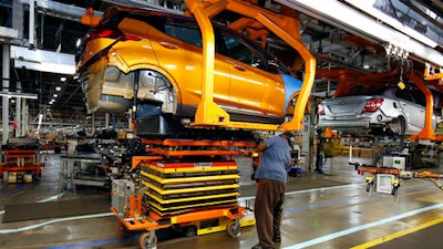 A battery is lifted into place for installation in the Chevrolet Bolt EV at the General Motors Orion Assembly plant Friday, Nov. 4, 2016, in Orion Township, Mich. The Chevrolet Bolt can go more than 200 miles on battery power and will cost less than the average new vehicle in the U.S. But it's unclear whether the car can do much to shift America from gasoline to electricity in an era of $2 prices at the pump.