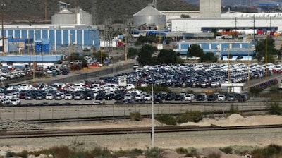 In this Nov. 21, 2013, file photo, cars sit at the General Motors plant where Chevrolet Sonics, Cadillac SRXs and Captiva SUVs are assembled in Ramos Arizpe, Mexico. U.S. President-elect Donald Trump’s election could bring some upheaval to the U.S. auto industry, which helped to lead the nation out of the Great Recession as U.S. sales rebounded. The industry is waiting to see if Trump will make good on promises to redo trade agreements and slap tariffs on cars manufactured in Mexico.