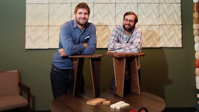 In this Sept. 27, 2016 photo, Ecovative Design co-founders Eben Bayer, left, and Gavin McIntyre pose in Green Island, N.Y. Ecovative Design is a business staking its growth on mycelium, the thread-like 'roots' of mushrooms. The mycelium grows around small pieces of stalks and stems to create a bound-together material that can be molded into soft packaging for glassware or pressed into the boards used for the footstools they recently began selling.