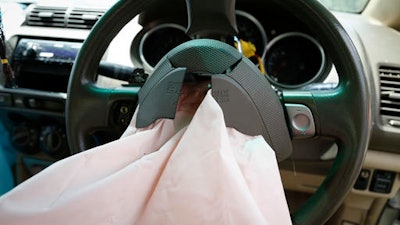 In this Monday, Nov. 7, 2016 photo, the exploded air bag that injured Rabiah binti Ibrahim hangs from the steering wheel in her Honda City in Slim River, Malaysia. Five Malaysians have died in accidents linked to faulty Takata air bags that are at the center of one of the world’s largest auto recalls.