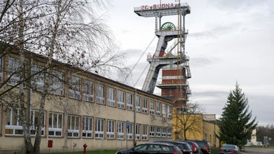 A view of the entrance to the Rudna copper mine with a miners flag at half-staff, in Polkowice, Poland, Wednesday, Nov. 30, 2016. The mine was hit by a tremor and cave-in, killing five miners and three are missing.