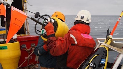Researchers prepare to drop a buoy into the Arctic Ocean. Scientists sponsored by the Office of Naval Research have traveled to the region to study the changing environment-and provide new tools to help the US Navy operate in a once-inaccessible area.
