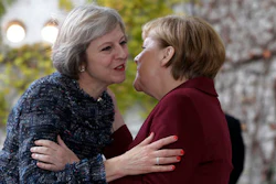 Britain's Prime Minister Theresa May, left, is welcomed by German Chancellor Angela Merkel prior to a meeting of the government heads of Germany, France, Italy, Spain and Britain with U.S. President Obama in the chancellery in Berlin, Germany, Friday, Nov. 18, 2016.