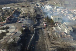 In this aerial view emergency services attend the scene of devastation after a tanker train derailed and a gas tank exploded in the village of Hitrino, northeastern Bulgaria, early Saturday, Dec. 10, 2016.